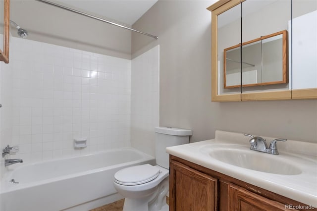 full bathroom with tiled shower / bath, vanity, and toilet