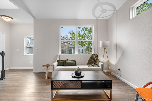 living area with wood finished floors and baseboards