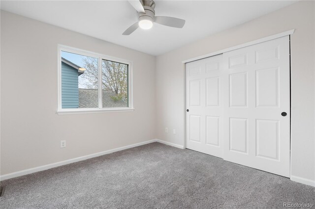 unfurnished bedroom with carpet floors, baseboards, a closet, and a ceiling fan