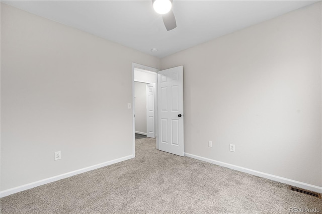 unfurnished room featuring a ceiling fan, carpet floors, and baseboards