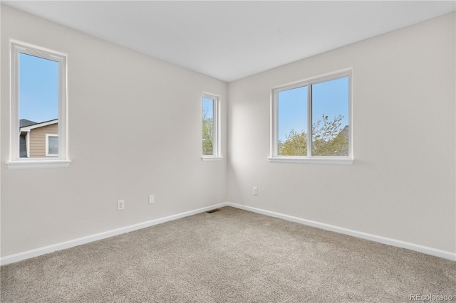 empty room with carpet floors and baseboards