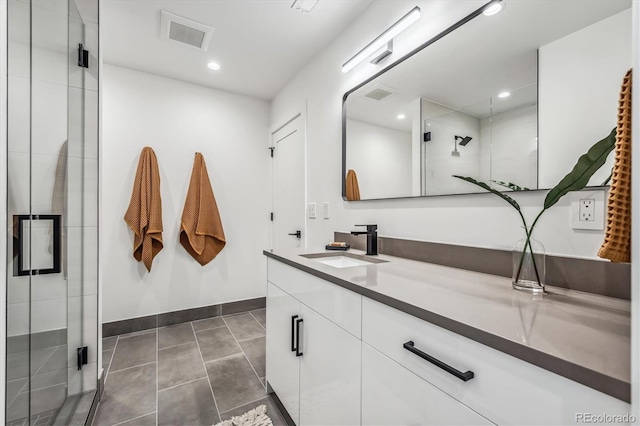 964 Quitman St, Denver, CO 80204 - full bath featuring vanity, baseboards, a stall shower, tile patterned flooring, and recessed lighting