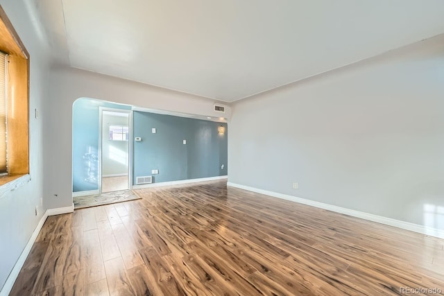 spare room featuring wood-type flooring