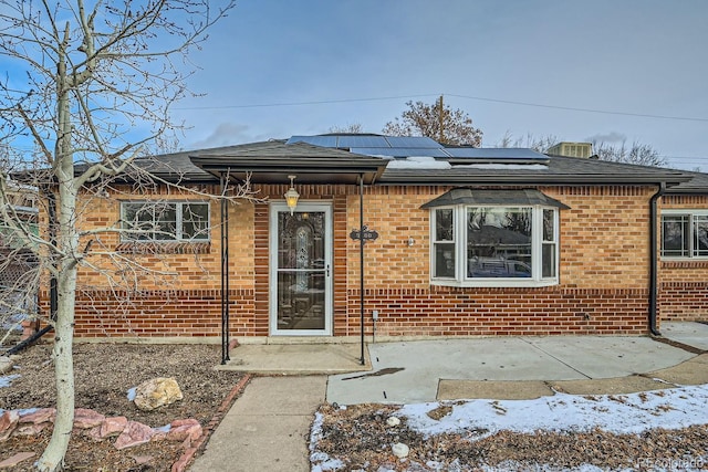 view of front facade featuring solar panels