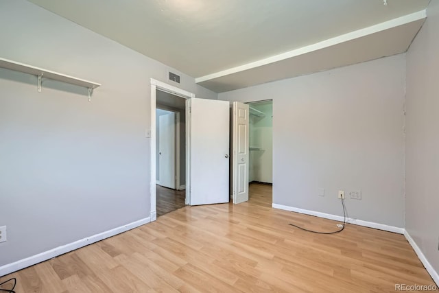 interior space featuring light hardwood / wood-style floors, a spacious closet, and a closet