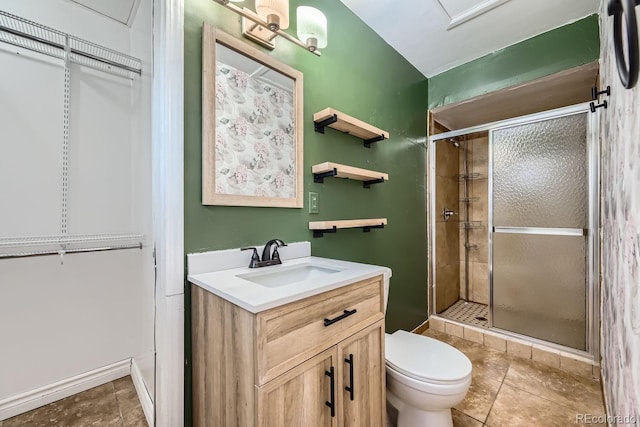 bathroom featuring toilet, vanity, and walk in shower