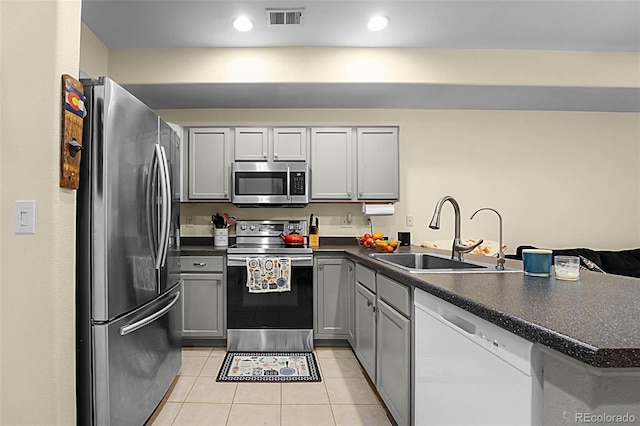 2143 Coronado Pkwy Unit C, Denver, CO 80229 - kitchen with appliances with stainless steel finishes, dark countertops, a peninsula, and recessed lighting