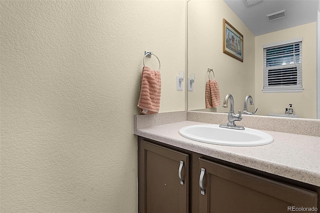 2143 Coronado Pkwy Unit C, Denver, CO 80229 - bathroom with vanity and a textured wall