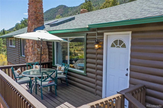 9850 Mohawk Trl, Cascade, CO 80809 - wooden deck with outdoor dining space and a mountain view