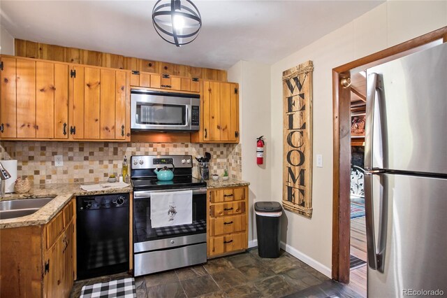 9850 Mohawk Trl, Cascade, CO 80809 - kitchen with appliances with stainless steel finishes, baseboards, decorative backsplash, and a sink