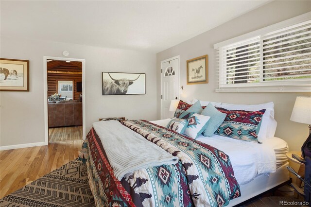 9850 Mohawk Trl, Cascade, CO 80809 - bedroom with wood finished floors, multiple windows, and baseboards