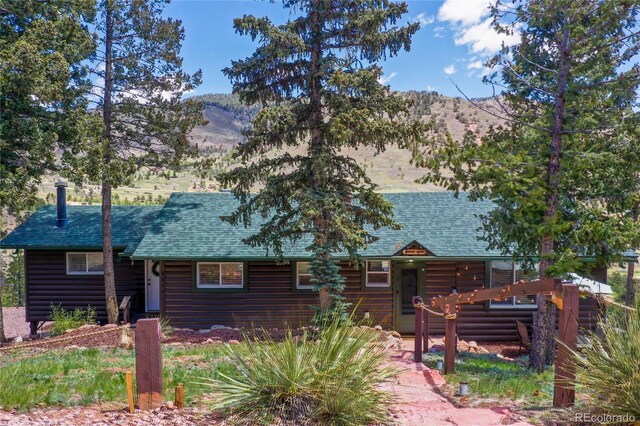 9850 Mohawk Trl, Cascade, CO 80809 - log cabin featuring a mountain view, log veneer siding, and a shingled roof