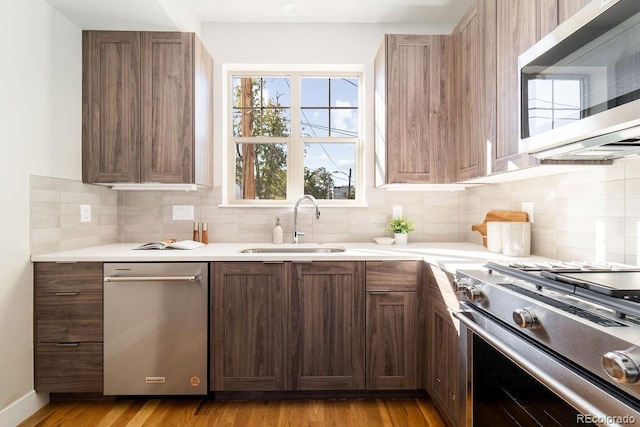 2828 N Federal Blvd, Denver, CO 80211 - kitchen with stainless steel appliances, a sink, tasteful backsplash, and light countertops