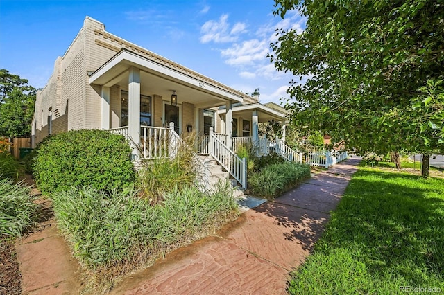 1024 34th St, Denver, CO 80205 - view of front of property featuring a porch and brick siding