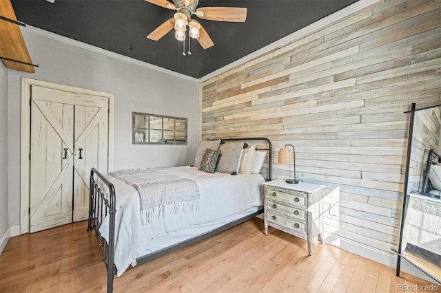 1024 34th St, Denver, CO 80205 - bedroom with wood walls, wood finished floors, ornamental molding, and ceiling fan