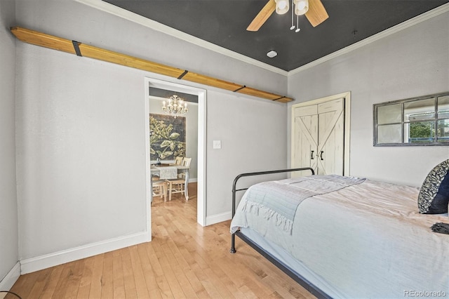 1024 34th St, Denver, CO 80205 - bedroom featuring a chandelier, light wood-style floors, ornamental molding, and a ceiling fan