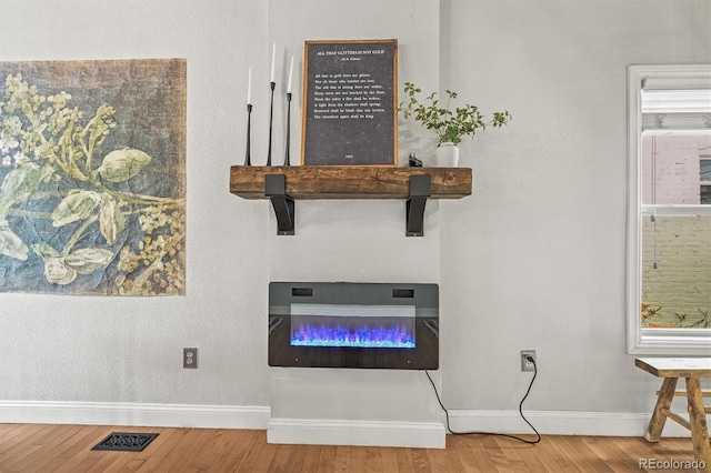 1024 34th St, Denver, CO 80205 - detailed view of wood finished floors and a glass covered fireplace
