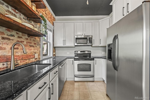 1024 34th St, Denver, CO 80205 - kitchen featuring appliances with stainless steel finishes, open shelves, white cabinetry, dark stone countertops, and light tile patterned floors