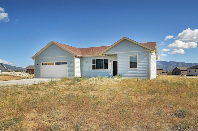 ranch-style house with a mountain view and a garage