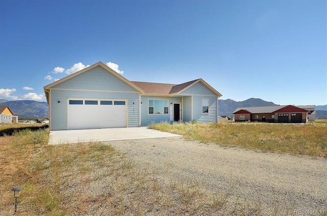 view of front of home featuring a garage and a mountain view