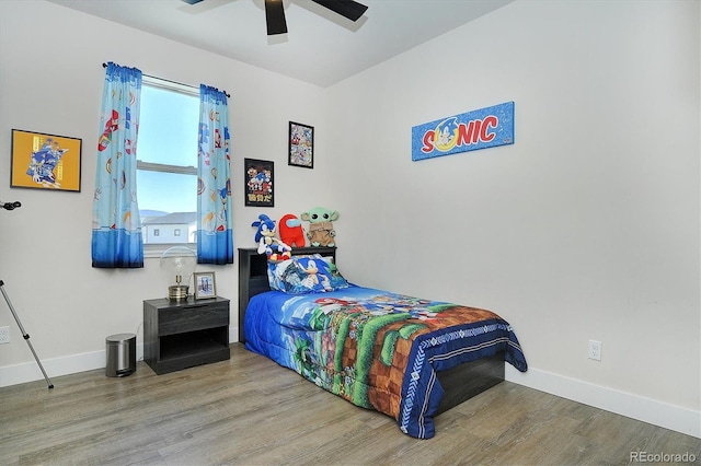 bedroom with wood-type flooring and ceiling fan