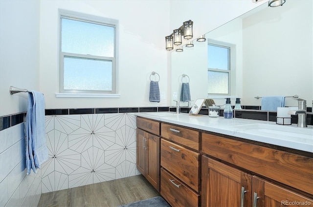 bathroom featuring vanity and tile walls