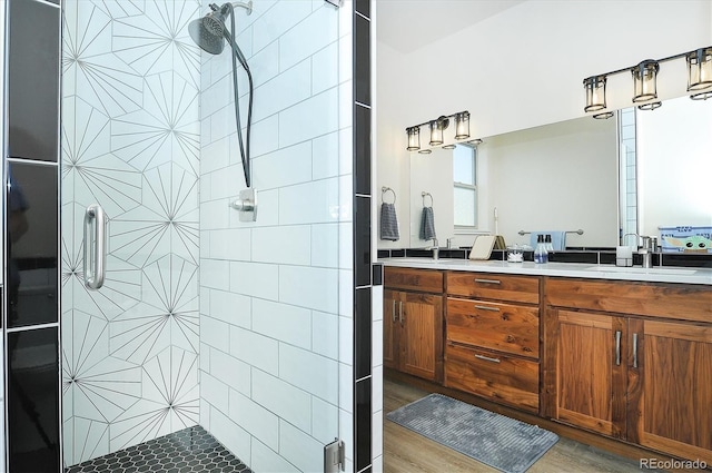 bathroom with a shower with door and vanity