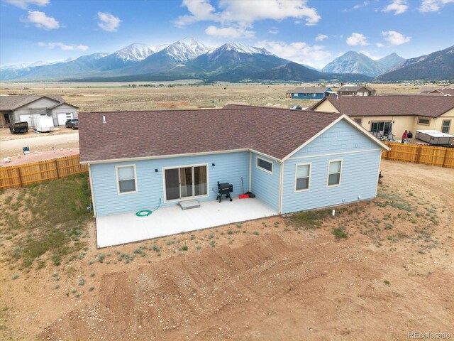 15626 Paintbrush St, Buena Vista, CO 81211 - back of property with a mountain view, a patio area, and a shingled roof