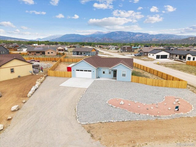 15626 Paintbrush St, Buena Vista, CO 81211 - view of front facade with a residential view, a mountain view, driveway, and a garage