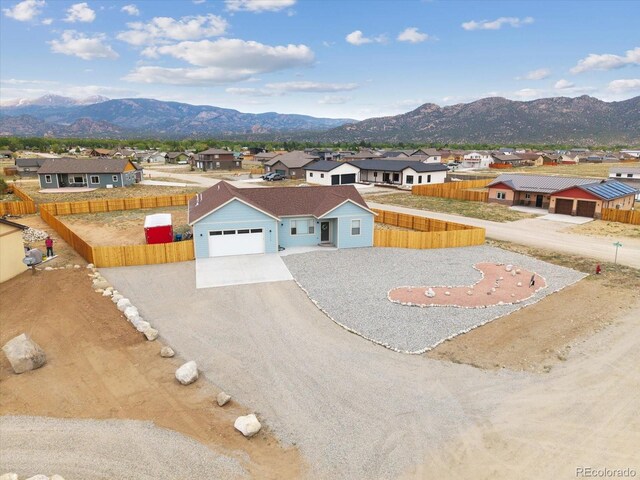 15626 Paintbrush St, Buena Vista, CO 81211 - view of front of property with a residential view, a mountain view, and a garage