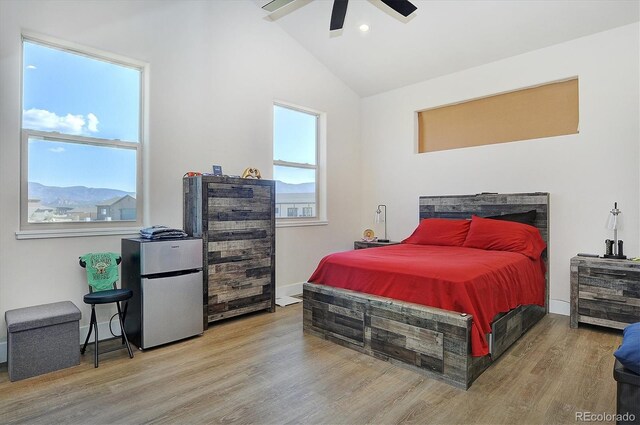 15626 Paintbrush St, Buena Vista, CO 81211 - bedroom featuring freestanding refrigerator, wood finished floors, vaulted ceiling, and ceiling fan