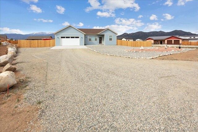 15626 Paintbrush St, Buena Vista, CO 81211 - ranch-style house featuring driveway, a mountain view, and a garage