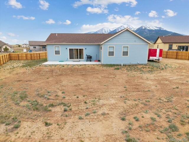 15626 Paintbrush St, Buena Vista, CO 81211 - back of property with a patio, a mountain view, and a fenced backyard