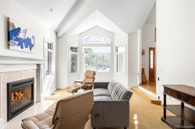 interior space with vaulted ceiling, baseboards, and a fireplace