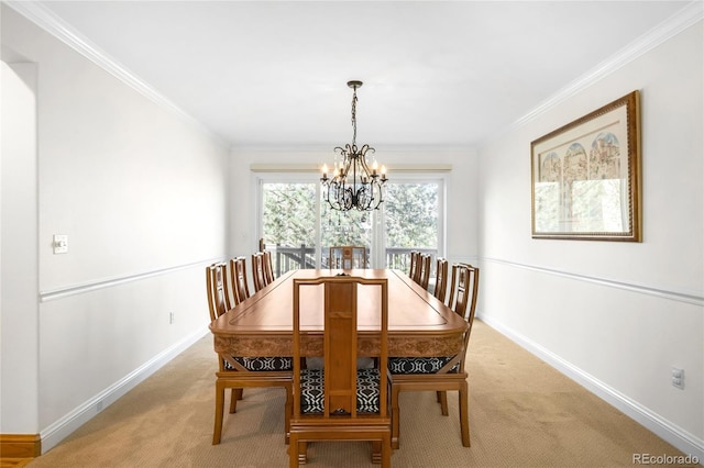 dining room with light carpet, ornamental molding, a chandelier, and baseboards