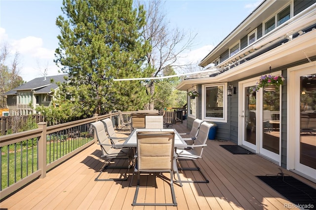 wooden terrace featuring outdoor dining area