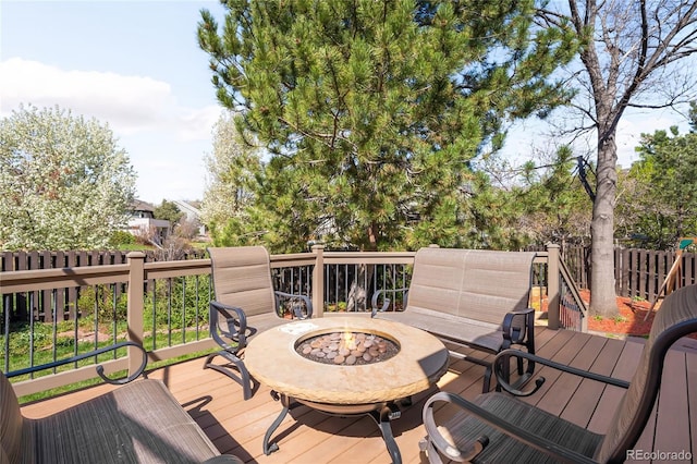 wooden deck with an outdoor fire pit