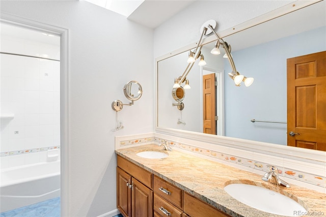 full bathroom with a sink and double vanity