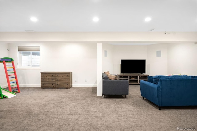carpeted living area featuring recessed lighting and baseboards