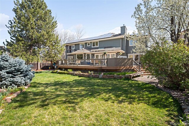 1437 Cassin Ct, Boulder, CO 80303 - rear view of property with roof mounted solar panels, a chimney, and a wooden deck