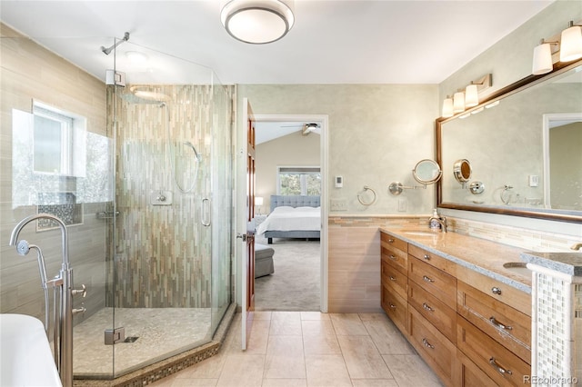1437 Cassin Ct, Boulder, CO 80303 - full bathroom featuring double vanity, a stall shower, tile patterned flooring, tile walls, and vaulted ceiling