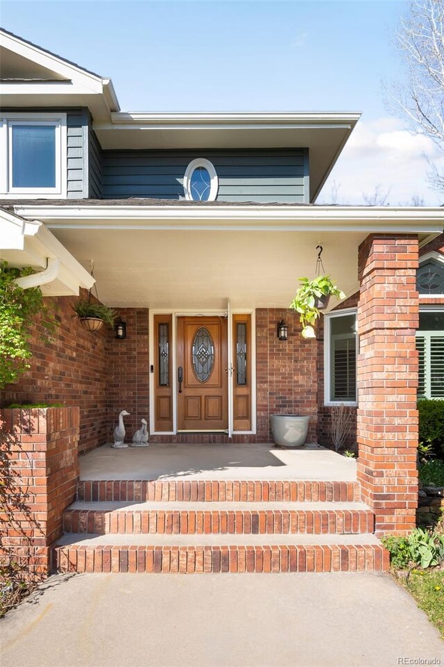 1437 Cassin Ct, Boulder, CO 80303 - view of exterior entry with a porch and brick siding