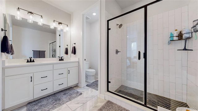 bathroom featuring vanity, toilet, and walk in shower