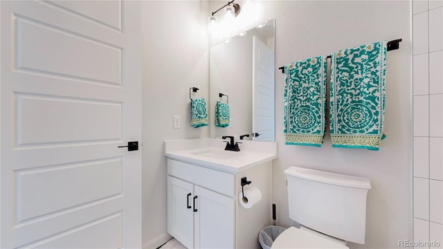 bathroom featuring vanity and toilet