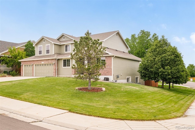1477 Serene Dr, Erie, CO 80516 - view of front of property featuring a garage, a front lawn, brick siding, and concrete driveway