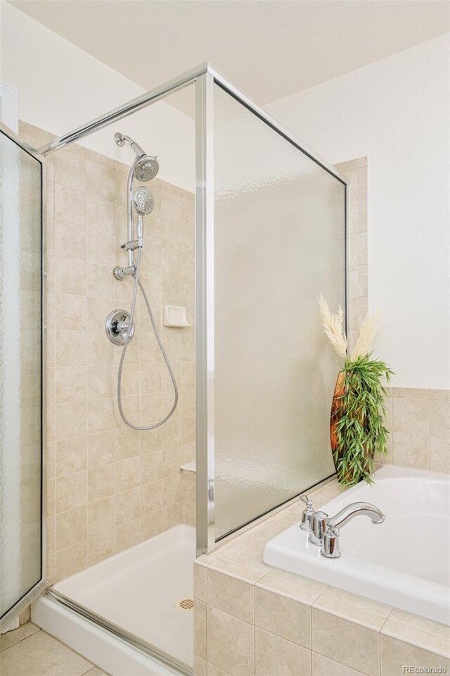 1477 Serene Dr, Erie, CO 80516 - full bath featuring a stall shower and a garden tub