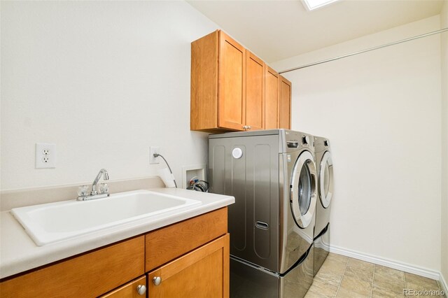 1477 Serene Dr, Erie, CO 80516 - laundry room with separate washer and dryer, cabinet space, and baseboards