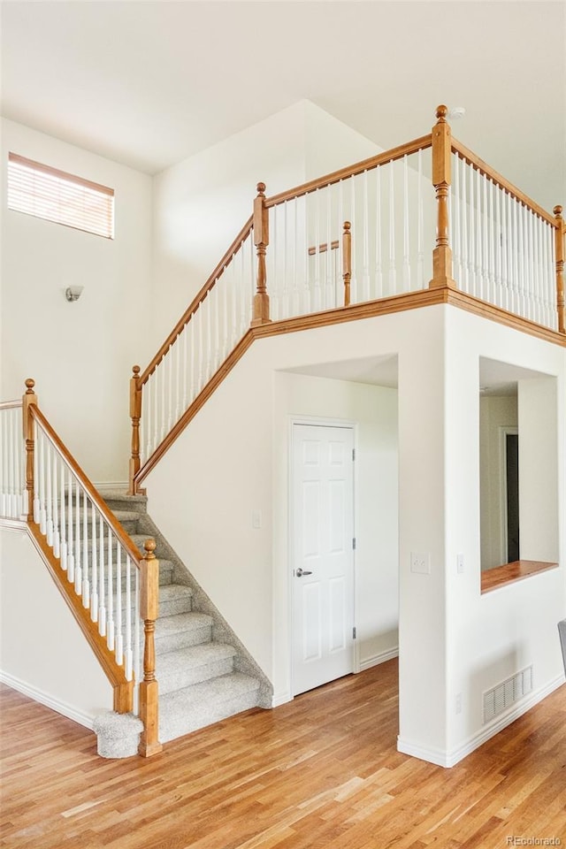1477 Serene Dr, Erie, CO 80516 - stairway featuring wood finished floors and baseboards