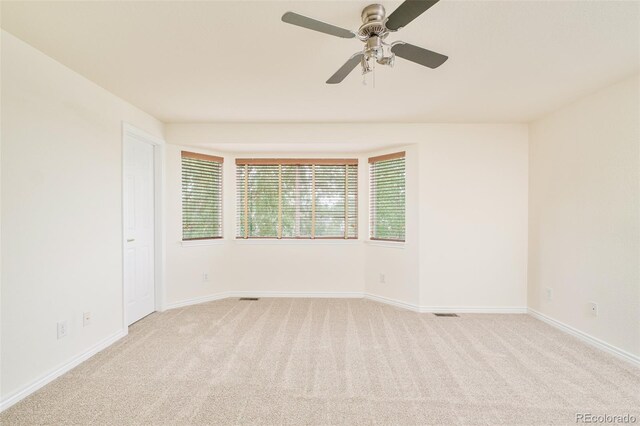 1477 Serene Dr, Erie, CO 80516 - spare room featuring light carpet, baseboards, and ceiling fan