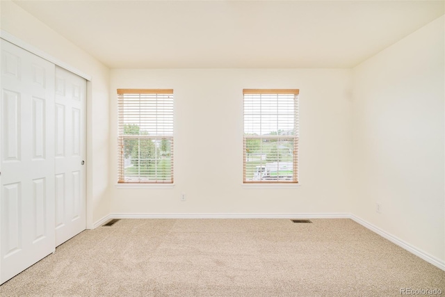 1477 Serene Dr, Erie, CO 80516 - unfurnished bedroom featuring light carpet, multiple windows, and baseboards